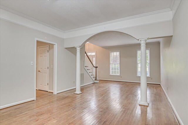 3696 El Cordero Ranch Springs Rd, Augusta, GA 30907 - spare room with stairway, light wood finished floors, arched walkways, crown molding, and baseboards