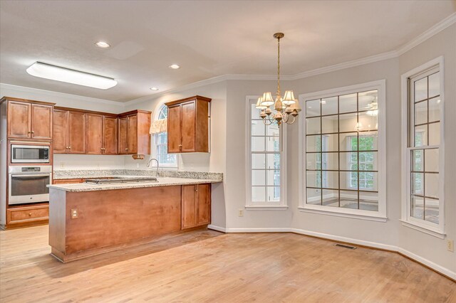 3696 El Cordero Ranch Springs Rd, Augusta, GA 30907 - kitchen featuring appliances with stainless steel finishes, brown cabinetry, light wood-type flooring, a chandelier, and a peninsula