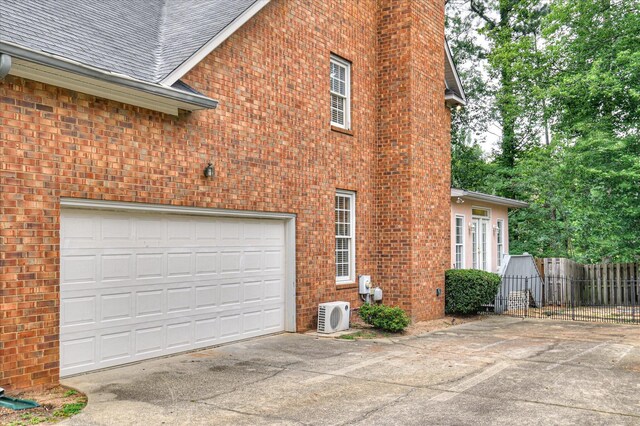 3696 El Cordero Ranch Springs Rd, Augusta, GA 30907 - view of home's exterior featuring a cooling unit, concrete driveway, brick siding, and roof with shingles