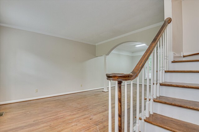 3696 El Cordero Ranch Springs Rd, Augusta, GA 30907 - staircase featuring arched walkways, wood finished floors, crown molding, and baseboards
