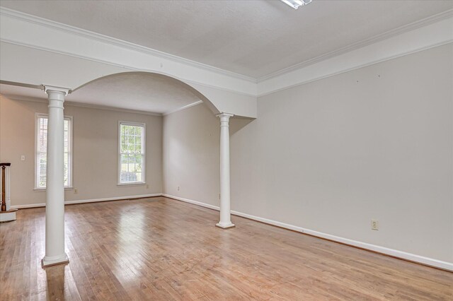 3696 El Cordero Ranch Springs Rd, Augusta, GA 30907 - empty room with ornamental molding, wood finished floors, baseboards, arched walkways, and ornate columns