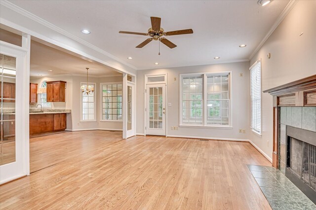 3696 El Cordero Ranch Springs Rd, Augusta, GA 30907 - unfurnished living room with a tile fireplace, light wood-type flooring, plenty of natural light, crown molding, and recessed lighting