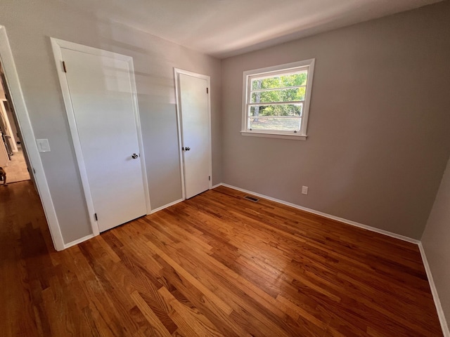 unfurnished bedroom with wood-type flooring