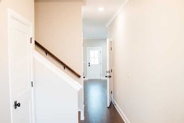 corridor with dark wood-style floors, recessed lighting, ornamental molding, baseboards, and stairs