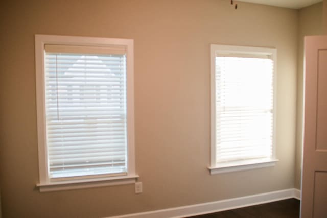 spare room featuring plenty of natural light and baseboards