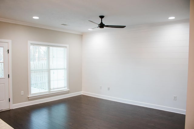 empty room with dark wood-style flooring, a wealth of natural light, and baseboards