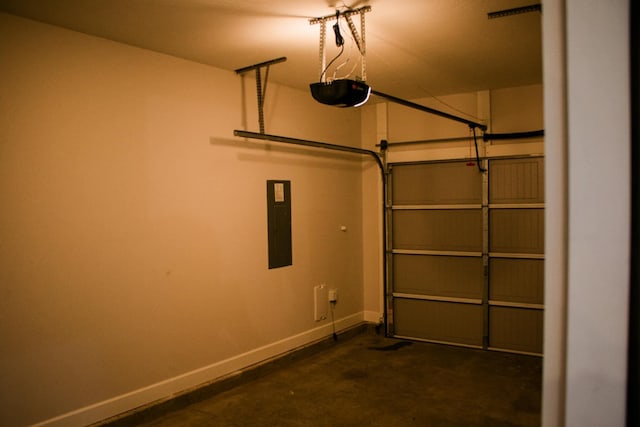 garage featuring electric panel, baseboards, and a garage door opener