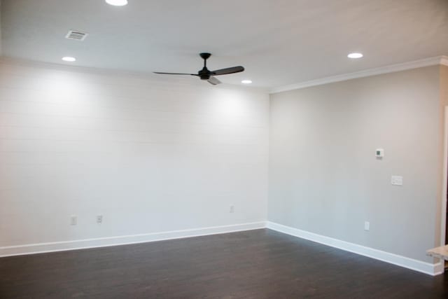 spare room with dark wood-style flooring, crown molding, recessed lighting, visible vents, and baseboards