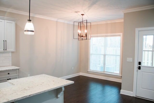 kitchen featuring ornamental molding, dark wood finished floors, white cabinetry, and decorative backsplash