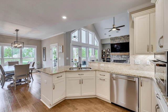 137 Elgin Ln, Mccormick, SC 29835 - kitchen with a healthy amount of sunlight, a sink, ceiling fan with notable chandelier, a peninsula, and appliances with stainless steel finishes