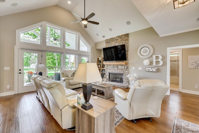 137 Elgin Ln, Mccormick, SC 29835 - living room with ceiling fan, a fireplace, a healthy amount of sunlight, and high vaulted ceiling