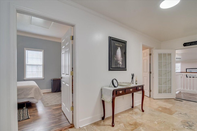 hall with french doors, a wealth of natural light, and ornamental molding