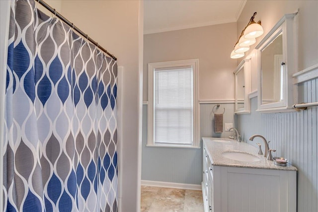 bathroom featuring a wealth of natural light, vanity, and ornamental molding