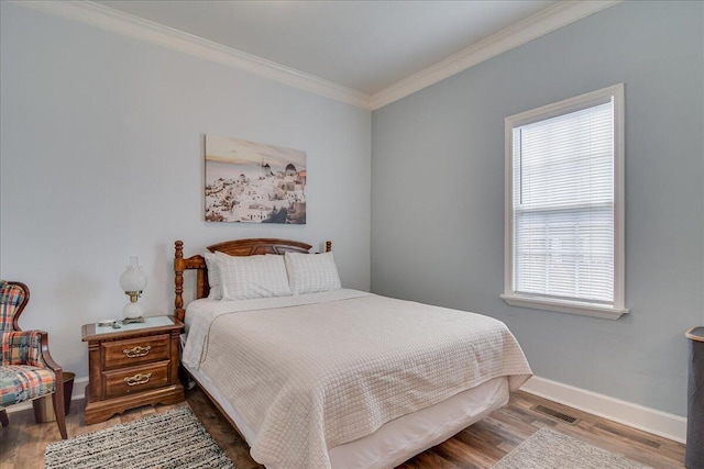 bedroom with crown molding and hardwood / wood-style floors