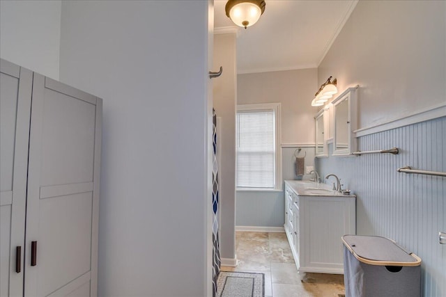 bathroom featuring crown molding and vanity