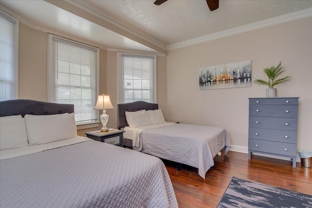 bedroom with ceiling fan, crown molding, dark wood-type flooring, and a textured ceiling