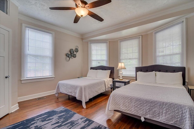 bedroom featuring hardwood / wood-style floors, a textured ceiling, ceiling fan, and crown molding