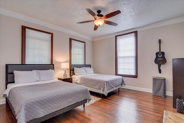 bedroom with a textured ceiling, ceiling fan, dark hardwood / wood-style flooring, and crown molding