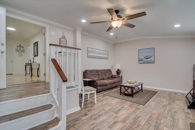 living room featuring wood-type flooring, lofted ceiling, ceiling fan, and crown molding