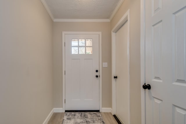 doorway with light wood finished floors, crown molding, baseboards, and a textured ceiling