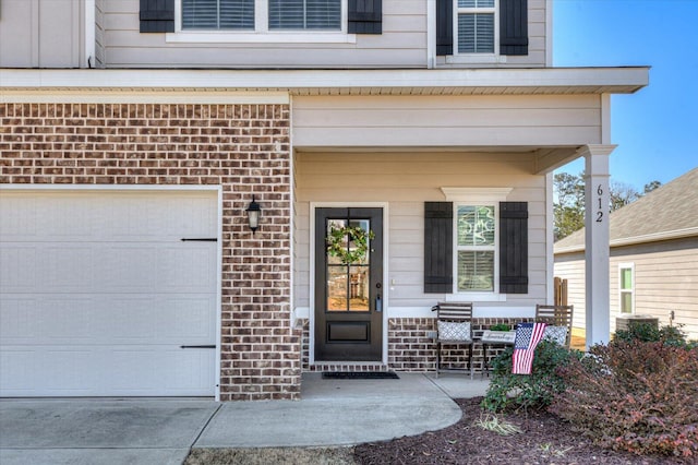 property entrance with central AC and a garage