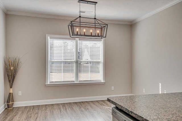 unfurnished dining area with crown molding, plenty of natural light, and a notable chandelier