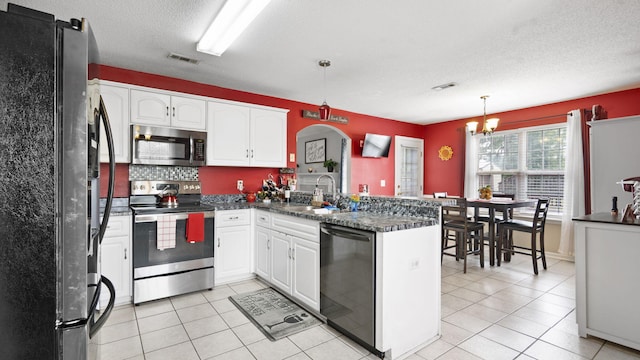 1518 Sandstone Ln, Hephzibah, GA 30815 - kitchen featuring appliances with stainless steel finishes, a sink, a peninsula, dark countertops, and white cabinets