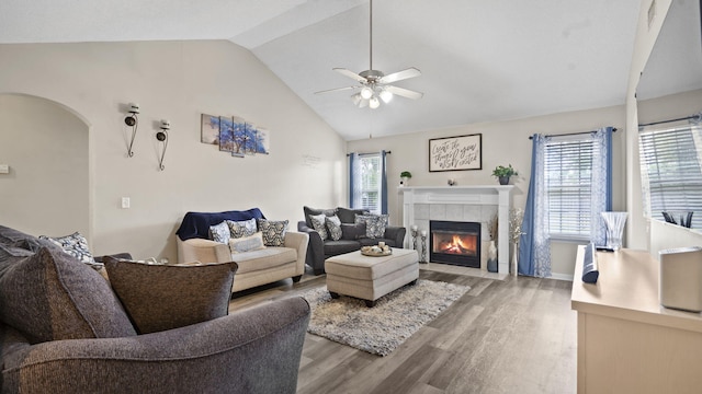 1518 Sandstone Ln, Hephzibah, GA 30815 - living area with light wood-style floors, ceiling fan, a tiled fireplace, arched walkways, and high vaulted ceiling