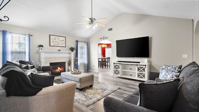 1518 Sandstone Ln, Hephzibah, GA 30815 - living room with arched walkways, ceiling fan, light wood-type flooring, a fireplace, and high vaulted ceiling