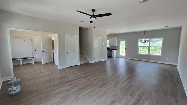 1759 Storm Branch Rd, Beech Island, SC 29842 - unfurnished living room featuring wood finished floors, ceiling fan, stairs, and a chandelier