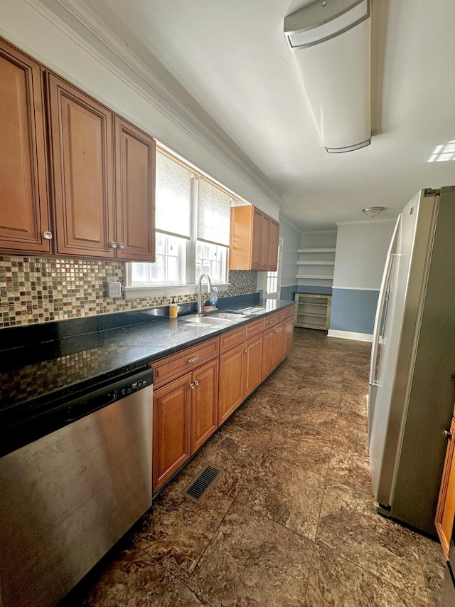 kitchen with dark countertops, brown cabinetry, stainless steel appliances, and decorative backsplash