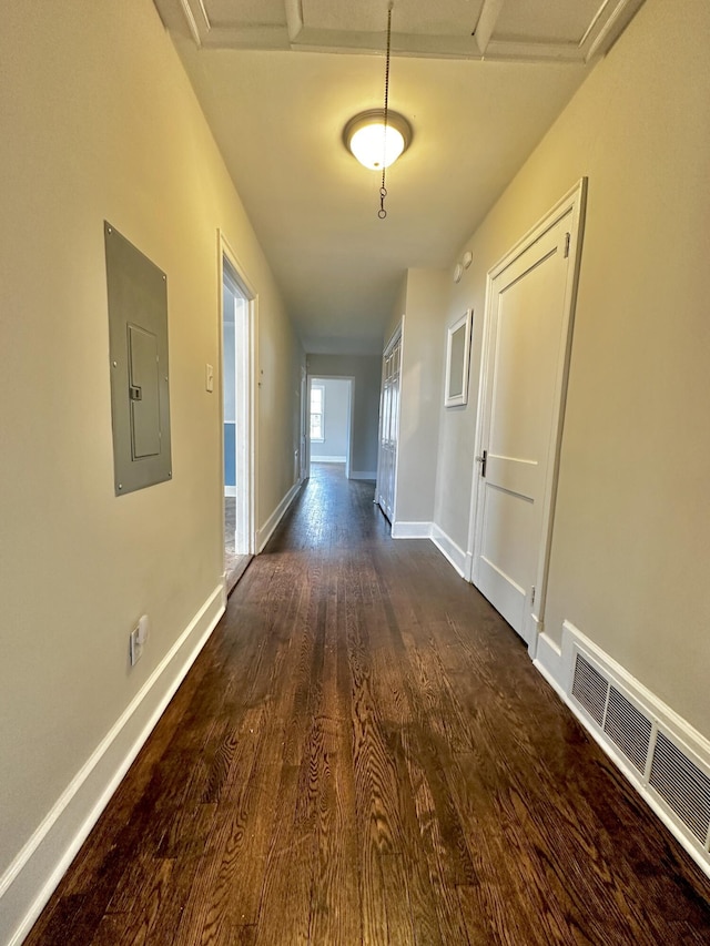 corridor featuring baseboards, electric panel, visible vents, and dark wood-type flooring