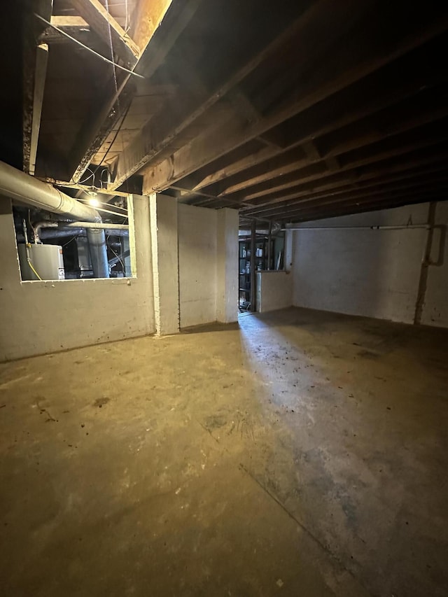 unfinished basement featuring water heater