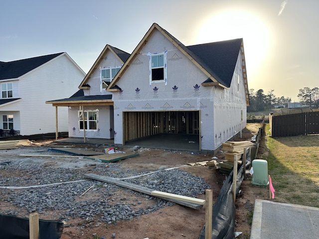 unfinished property with a garage, fence, and a patio