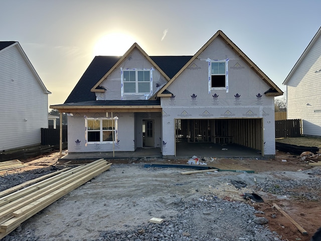 property under construction featuring a garage, a patio, fence, and stucco siding