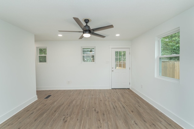 spare room featuring light hardwood / wood-style floors and ceiling fan