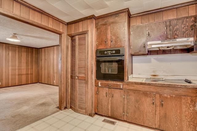 1775 Metasville Rd, Lincolnton, GA 30817 - kitchen featuring wooden walls, visible vents, tile countertops, under cabinet range hood, and black appliances