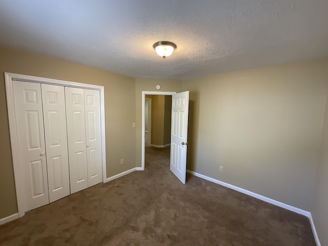 930 Hunting Horn Way, Evans, GA 30809 - unfurnished bedroom with carpet flooring, baseboards, a closet, and a textured ceiling