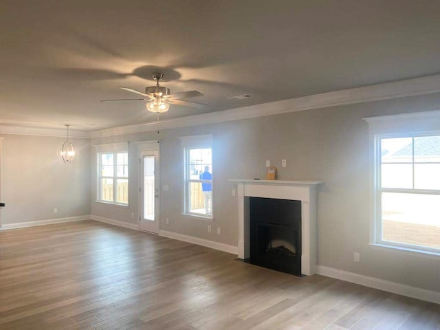 323 Granard St, Grovetown, GA 30813 - unfurnished living room with light wood-type flooring, crown molding, a fireplace with flush hearth, a ceiling fan, and a chandelier