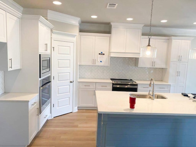 323 Granard St, Grovetown, GA 30813 - kitchen featuring stainless steel appliances, light wood-style flooring, white cabinetry, light countertops, and ornamental molding