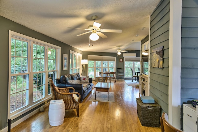 123 Tara Dr, Mccormick, SC 29835 - living area featuring a textured ceiling, a ceiling fan, light wood-type flooring, and vaulted ceiling