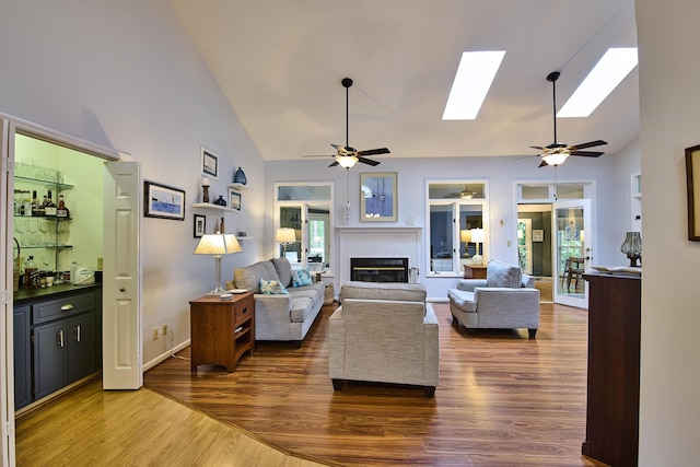123 Tara Dr, Mccormick, SC 29835 - living area with a ceiling fan, high vaulted ceiling, wood finished floors, a fireplace, and a skylight