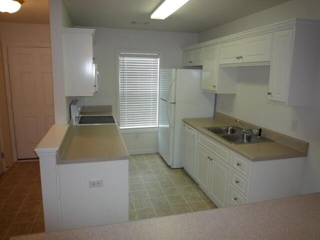 7423 Exuma Dr, Augusta, GA 30909 - kitchen with a sink, light floors, white cabinetry, range, and white dishwasher