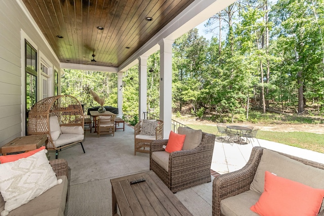 view of patio featuring a porch, an outdoor living space, a ceiling fan, and outdoor dining area