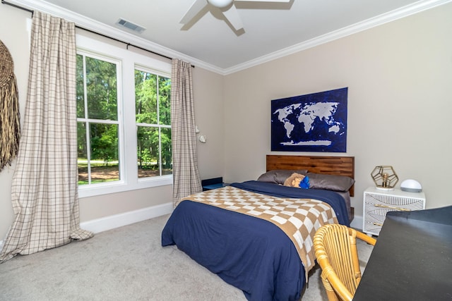 bedroom with baseboards, carpet flooring, ceiling fan, visible vents, and crown molding