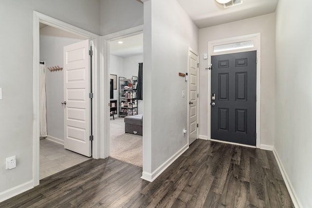 entryway with baseboards, dark wood-style flooring, and visible vents