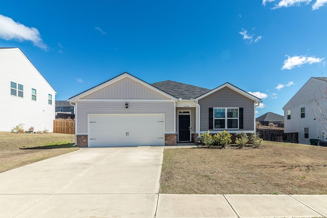 view of front of property with brick siding, a garage, driveway, and a front yard