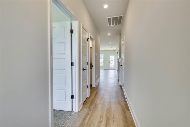 bathroom featuring shower / bath combination, visible vents, toilet, wood finished floors, and vanity