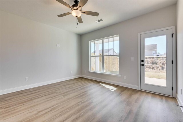 unfurnished room with carpet flooring, visible vents, and baseboards