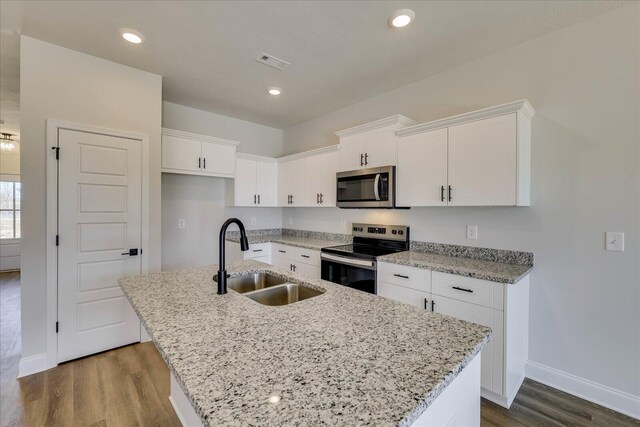 full bath with visible vents, a sink, a spacious closet, and a shower stall